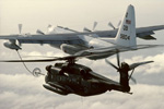 CH-53E Refueled by a C-130 Hercules - by George Hall